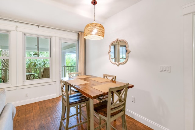 dining room with baseboards and dark wood finished floors