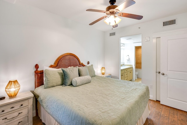 bedroom featuring light wood-style flooring, ensuite bath, and ceiling fan