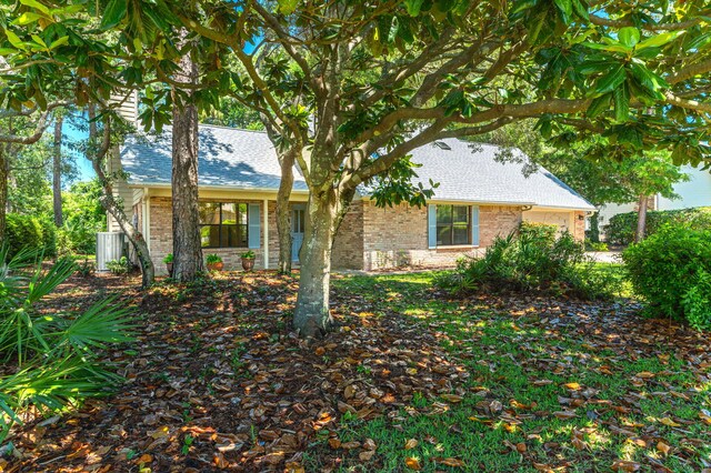 829 S Turnberry Cv, Niceville, FL 32578 - view of front of house featuring brick siding and roof with shingles