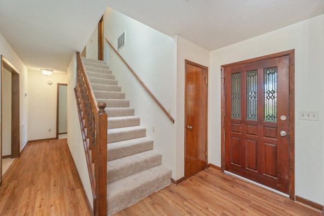829 S Turnberry Cv, Niceville, FL 32578 - foyer entrance featuring stairs, light wood-style flooring, and baseboards