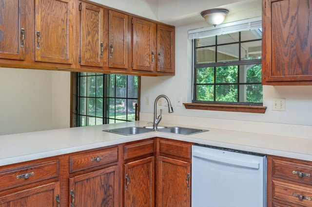829 S Turnberry Cv, Niceville, FL 32578 - kitchen featuring dishwasher, a sink, light countertops, and brown cabinetry