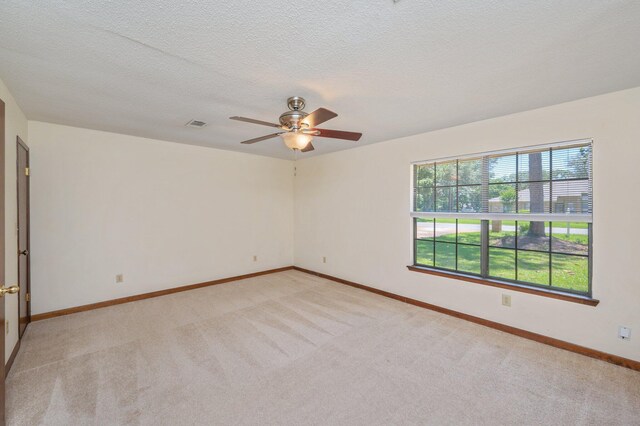 829 S Turnberry Cv, Niceville, FL 32578 - empty room featuring light carpet, ceiling fan, baseboards, and a textured ceiling