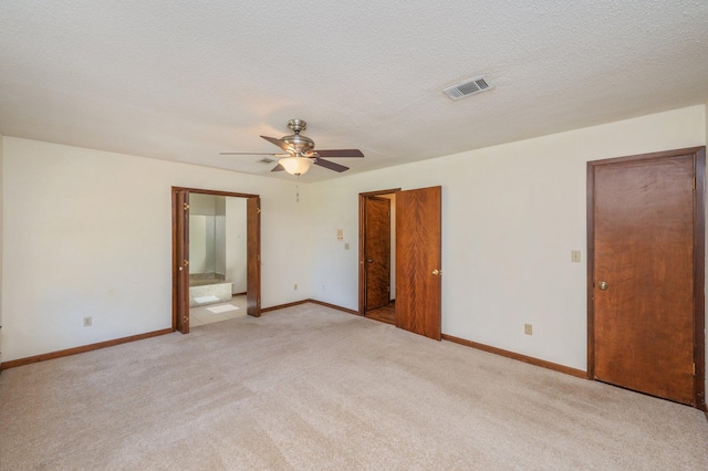 829 S Turnberry Cv, Niceville, FL 32578 - unfurnished bedroom with light carpet, baseboards, ensuite bathroom, and ceiling fan