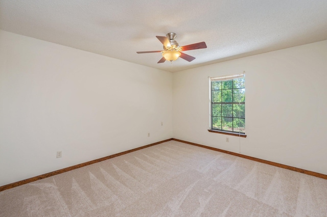 829 S Turnberry Cv, Niceville, FL 32578 - unfurnished room featuring light carpet, a ceiling fan, baseboards, and a textured ceiling
