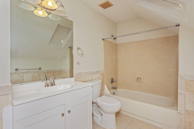 829 S Turnberry Cv, Niceville, FL 32578 - bathroom with tile patterned floors, tile walls, toilet, lofted ceiling, and vanity