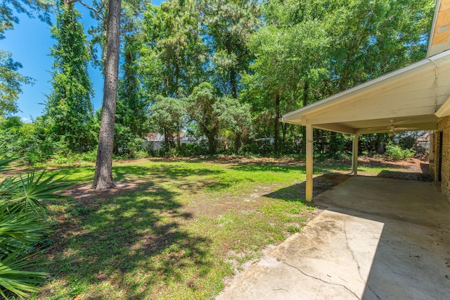 829 S Turnberry Cv, Niceville, FL 32578 - view of green lawn with a patio area, ceiling fan, concrete driveway, and a carport