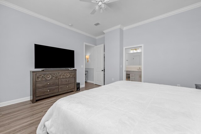 1233 Elderflower Dr, Niceville, FL 32578 - bedroom featuring crown molding, wood finished floors, baseboards, ensuite bath, and a ceiling fan