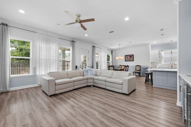 1233 Elderflower Dr, Niceville, FL 32578 - living area with a ceiling fan, light wood-style floors, recessed lighting, ornamental molding, and baseboards