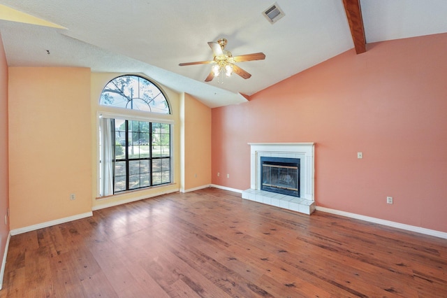 unfurnished living room with wood-type flooring, ceiling fan, a fireplace, and baseboards