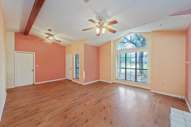 unfurnished living room with ceiling fan, wood-type flooring, and baseboards