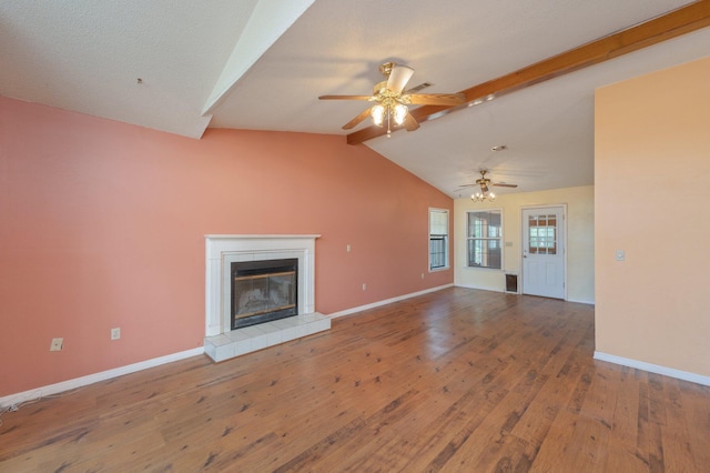 unfurnished living room with a ceiling fan, wood finished floors, a tile fireplace, and baseboards