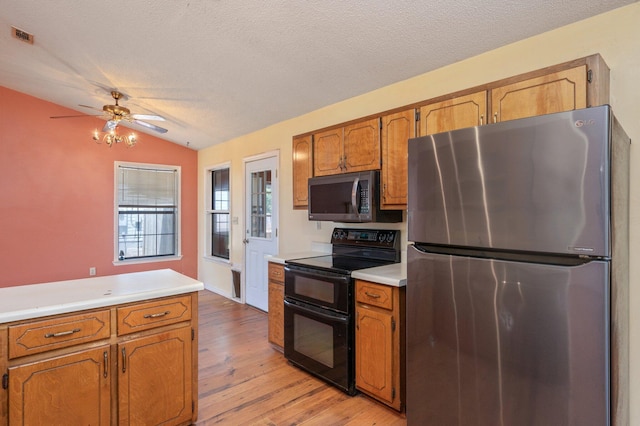 kitchen with stainless steel appliances, lofted ceiling, light wood-type flooring, brown cabinetry, and light countertops
