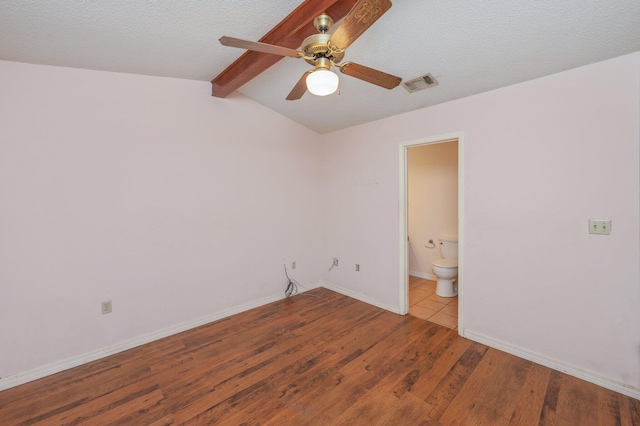 spare room featuring wood finished floors, a ceiling fan, and baseboards