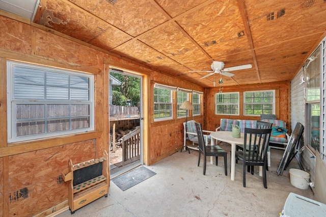 sunroom with a ceiling fan and outdoor dining area