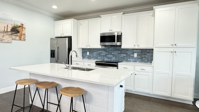 9 Inlet Heights Ln, Inlet Beach, FL 32461 - kitchen with stainless steel appliances, a sink, a kitchen breakfast bar, an island with sink, and white cabinets