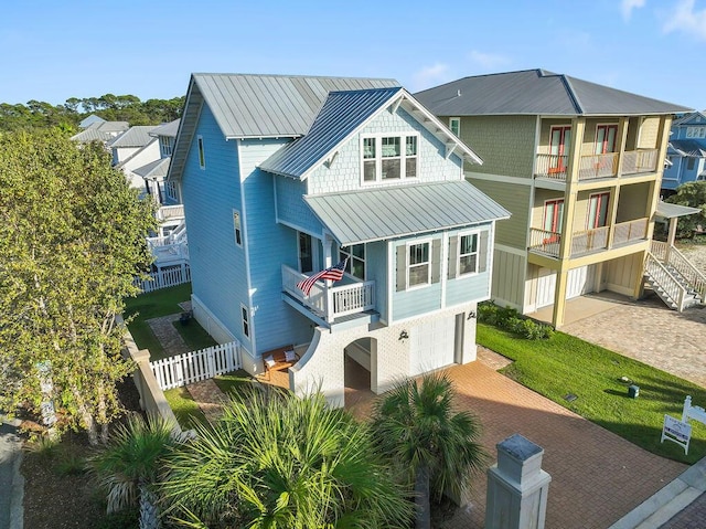 9 Inlet Heights Ln, Inlet Beach, FL 32461 - view of front of house with a balcony, an attached garage, decorative driveway, a standing seam roof, and fence