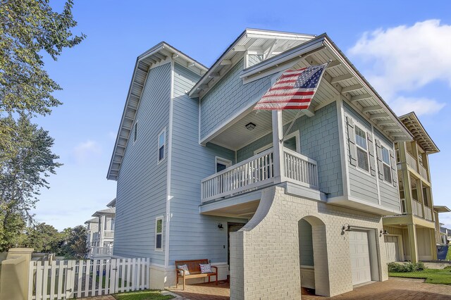 9 Inlet Heights Ln, Inlet Beach, FL 32461 - view of front facade with a balcony, an attached garage, fence, and cooling unit