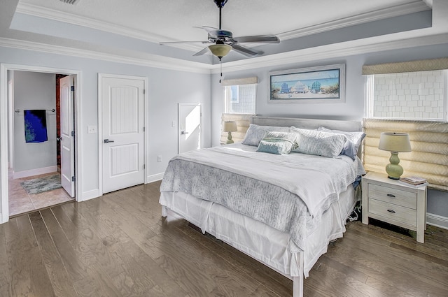9 Inlet Heights Ln, Inlet Beach, FL 32461 - bedroom with a tray ceiling, dark wood-style floors, crown molding, and baseboards