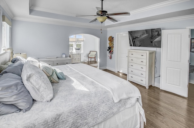 9 Inlet Heights Ln, Inlet Beach, FL 32461 - bedroom featuring arched walkways, dark wood finished floors, a tray ceiling, ornamental molding, and ceiling fan