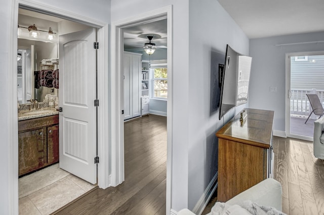 9 Inlet Heights Ln, Inlet Beach, FL 32461 - hallway with baseboards, wood finished floors, and a sink