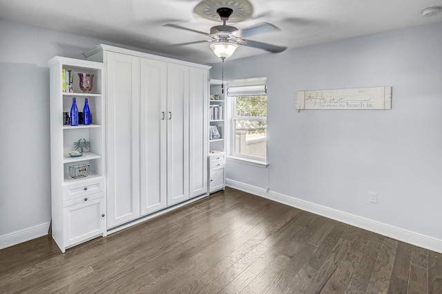 9 Inlet Heights Ln, Inlet Beach, FL 32461 - unfurnished bedroom with baseboards, dark wood finished floors, and a ceiling fan