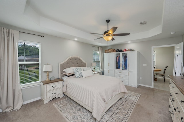 bedroom with light colored carpet, baseboards, multiple windows, and recessed lighting