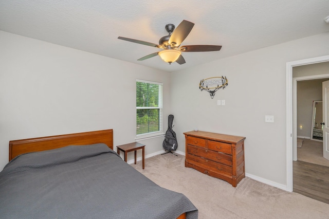 bedroom with baseboards, light colored carpet, and ceiling fan