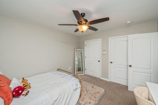 bedroom with light carpet, ceiling fan, and baseboards