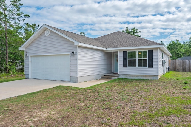 view of front of home featuring an attached garage, concrete driveway, and roof with shingles
