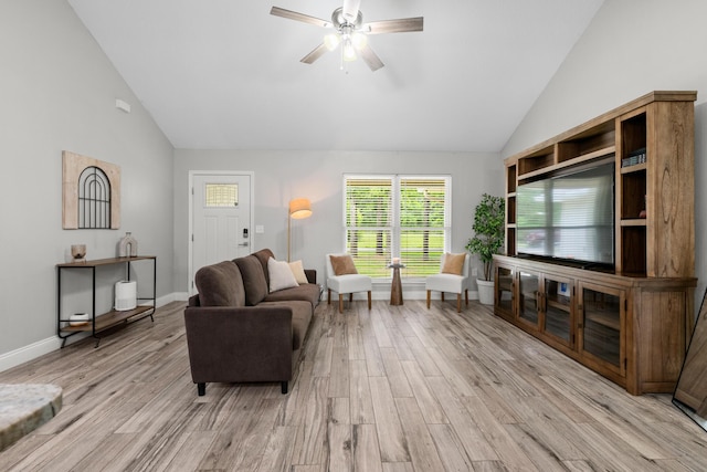 living area with light wood-style floors, a ceiling fan, high vaulted ceiling, and baseboards