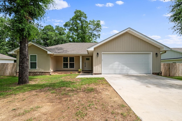 ranch-style home featuring an attached garage, concrete driveway, and roof with shingles
