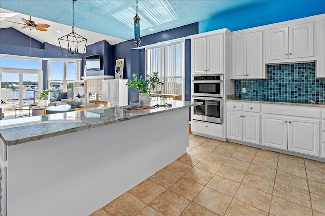 1280 Mahogany Mill Rd, Pensacola, FL 32507 - kitchen with double oven, tasteful backsplash, a ceiling fan, white cabinetry, and pendant lighting