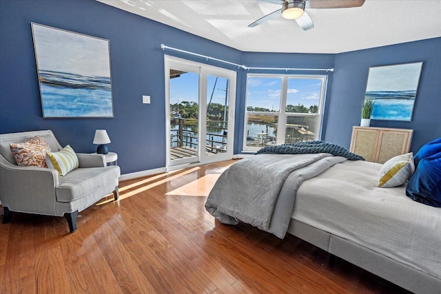 1280 Mahogany Mill Rd, Pensacola, FL 32507 - bedroom featuring access to exterior, wood finished floors, a water view, ceiling fan, and baseboards