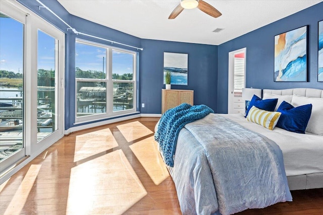 1280 Mahogany Mill Rd, Pensacola, FL 32507 - bedroom with wood finished floors, ceiling fan, and baseboards
