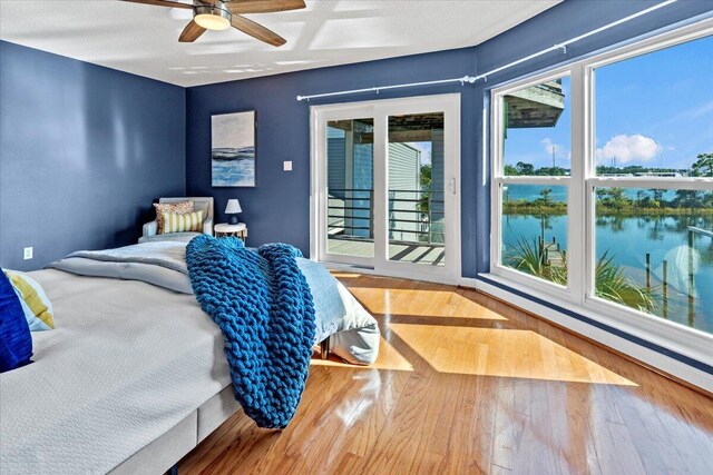 1280 Mahogany Mill Rd, Pensacola, FL 32507 - bedroom featuring access to exterior, multiple windows, a water view, and wood finished floors