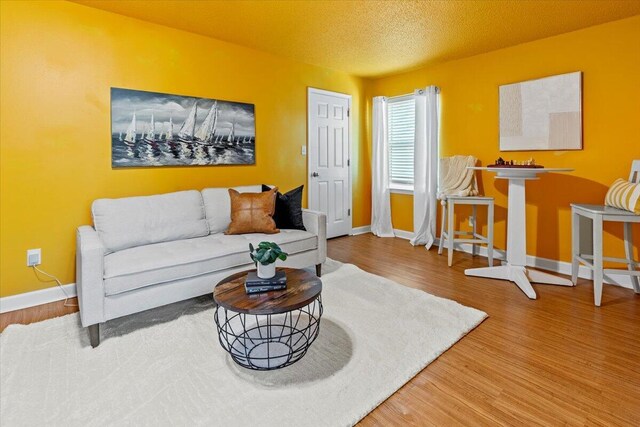 1280 Mahogany Mill Rd, Pensacola, FL 32507 - living area with wood finished floors, baseboards, and a textured ceiling