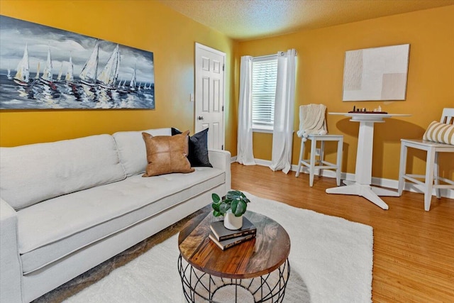 1280 Mahogany Mill Rd, Pensacola, FL 32507 - living area with wood finished floors, baseboards, and a textured ceiling