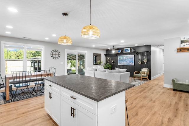 236 Little Canal Dr, Santa Rosa Beach, FL 32459 - kitchen featuring dark countertops, light wood-style floors, recessed lighting, and a center island