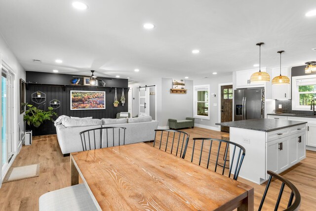 236 Little Canal Dr, Santa Rosa Beach, FL 32459 - dining room featuring a barn door, light wood-style flooring, recessed lighting, and ceiling fan