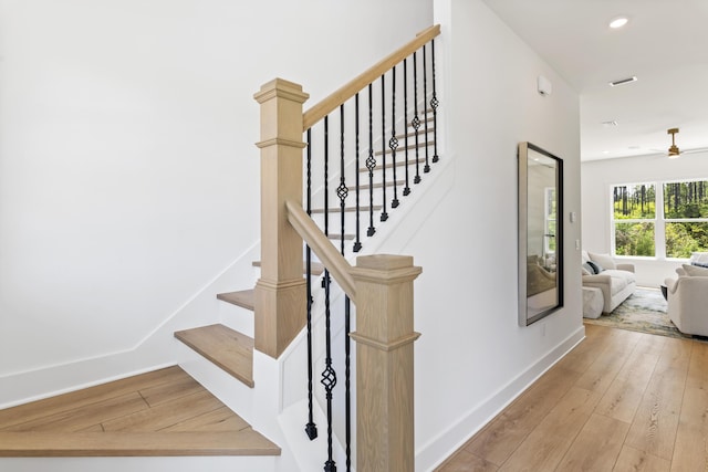 staircase featuring hardwood / wood-style floors, recessed lighting, baseboards, and ceiling fan