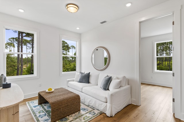 living area with light wood finished floors, baseboards, and recessed lighting