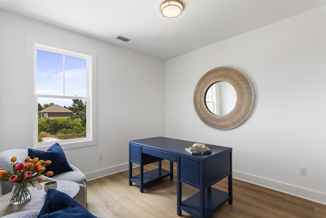 office area with baseboards and wood finished floors