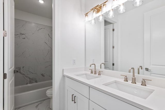 bathroom with marble look tiles, toilet, double vanity, and shower / tub combination