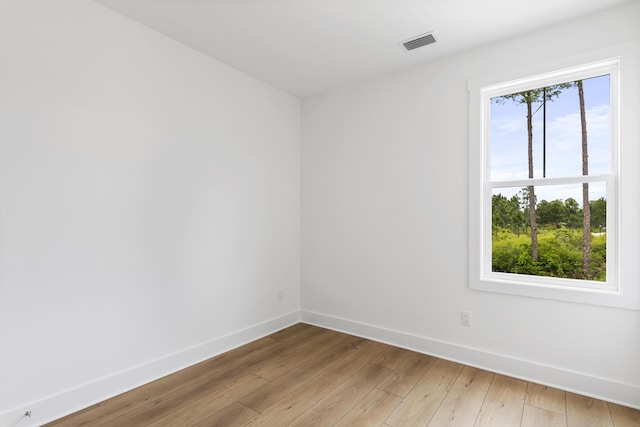 empty room featuring baseboards and light wood-style floors