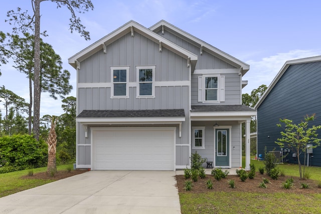 view of front of property featuring board and batten siding, a shingled roof, concrete driveway, and a garage