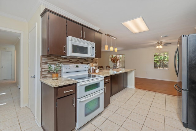 37 James Dr, Shalimar, FL 32579 - kitchen featuring white appliances, light tile patterned flooring, ornamental molding, decorative backsplash, and dark brown cabinetry
