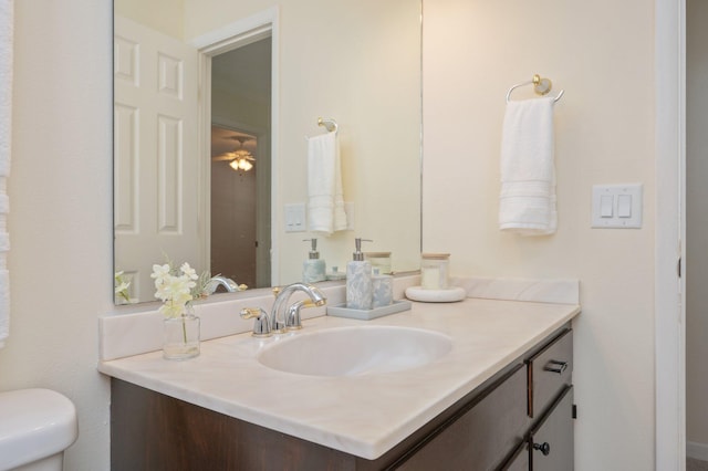 37 James Dr, Shalimar, FL 32579 - bathroom with vanity, toilet, and a ceiling fan