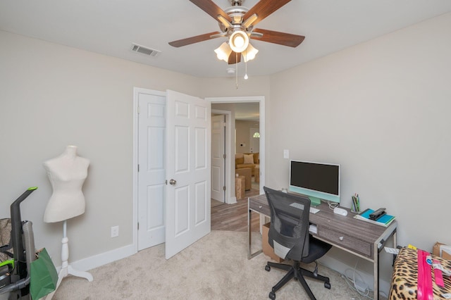 office area featuring a ceiling fan, light colored carpet, and baseboards
