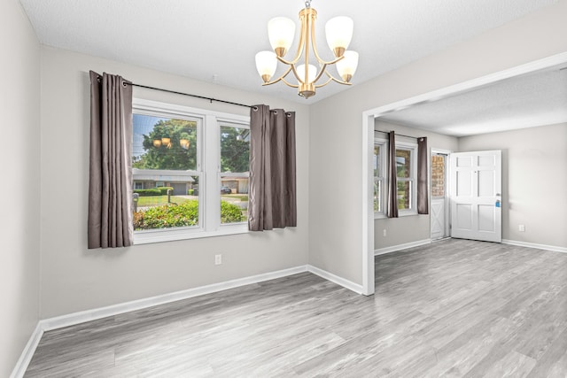 4360 Beau Terra Ln, Pensacola, FL 32514 - spare room with a chandelier, wood finished floors, and baseboards