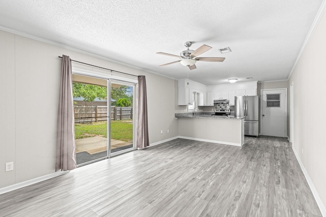 4360 Beau Terra Ln, Pensacola, FL 32514 - kitchen featuring appliances with stainless steel finishes, a textured ceiling, ornamental molding, a peninsula, and light wood-style floors